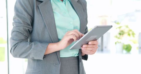 Businesswoman Using Tablet in Modern Corporate Environment - Download Free Stock Images Pikwizard.com