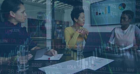 Diverse Businesswomen Analyzing Stock Trends in Modern Office