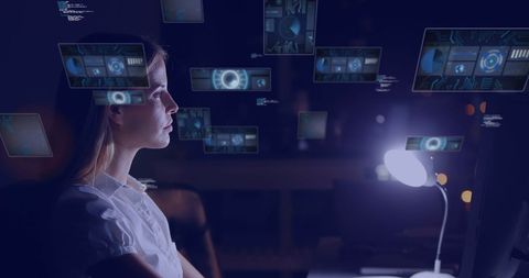 Woman analyzing digital technology in futuristic environment