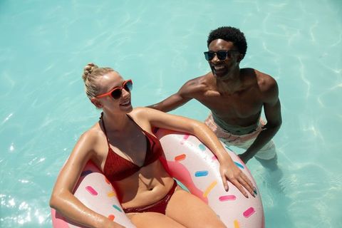 Enjoying Vacation in Pool with Inflatable Donut Ring