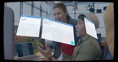 Team collaborating with augmented reality widgets in open office workspace