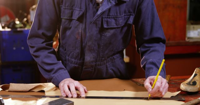 Craftsman Measuring and Cutting Leather in Workshop - Download Free Stock Images Pikwizard.com