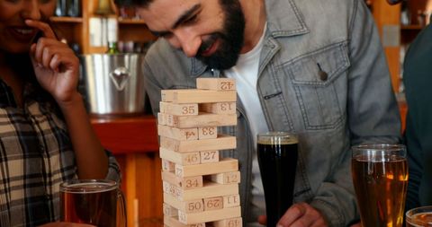Young Adults Playing Jenga at Social Gathering