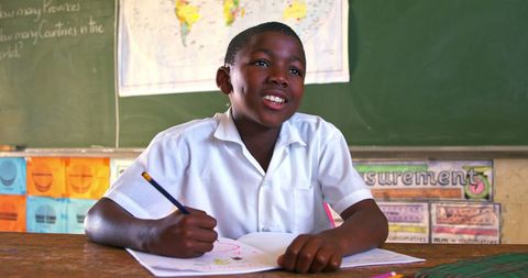 Attentive Schoolboy Writing During Classroom Lesson - Download Free Stock Images Pikwizard.com