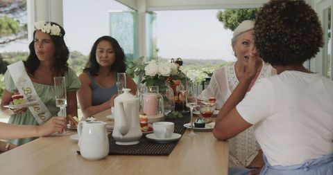 Women enjoying desserts and conversation at outdoor gathering