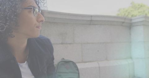 Contemplative Man Outdoors with Backpack Against Urban Backdrop - Download Free Stock Images Pikwizard.com