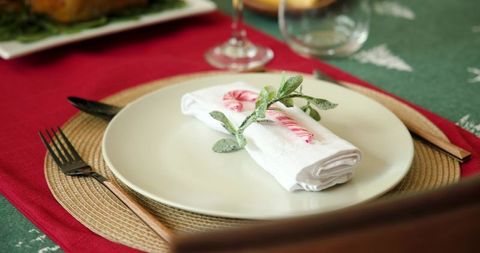 Festive holiday table setting with candy cane and napkin decor