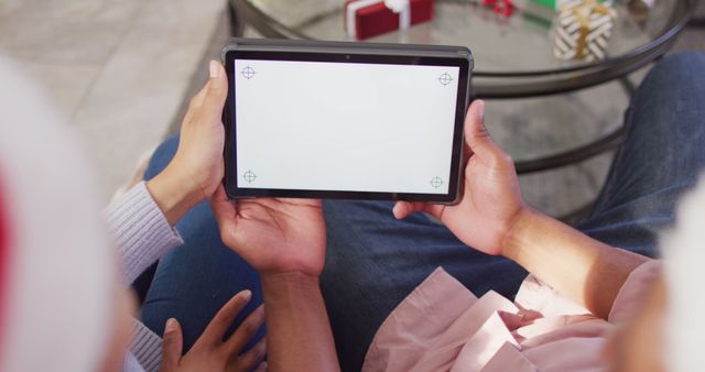 People Holding Tablet with Blank Screen for Customization Near Holiday Decorations - Download Free Stock Images Pikwizard.com