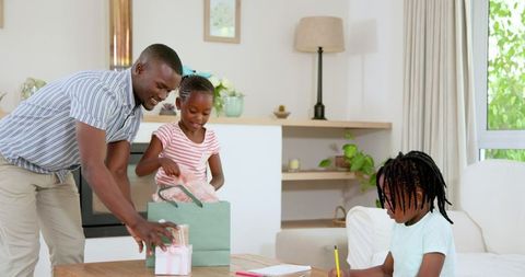 Father Helping Children with School Supplies at Home