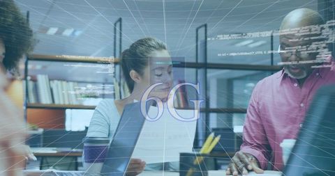 Colleagues collaborating on 6g technology innovation in modern office