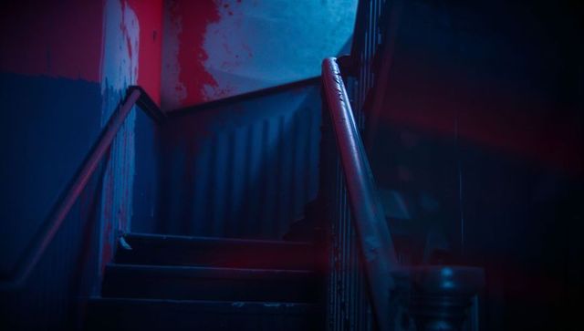 Moody Vintage Staircase with Red and Blue Lighting Effects