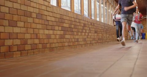 Teenage Students Running in School Hallway with Lively Energy