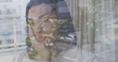 Young Asian Woman Behind Glass in Tranquil Reflection