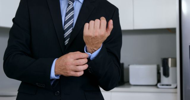 Businessman Adjusting Cufflinks Preparing for Work - Download Free Stock Images Pikwizard.com