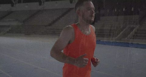 Athletic Man Jogging on Stadium Track