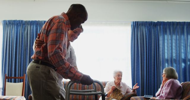 Senior Man Using Walker with Caregiver Assistance in Elderly Care Facility - Download Free Stock Images Pikwizard.com