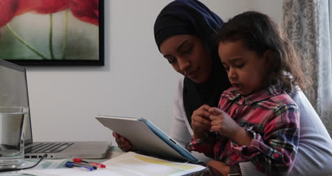 Mother and Daughter Using Tablet in Kitchen