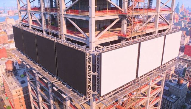 Displaying sunlit led billboard panels on high-rise steel frame at construction site