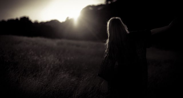 Silhouette of Woman Walking in Field at Sunset - Download Free Stock Photos Pikwizard.com