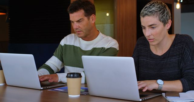 Colleagues Working on Laptops in Office Workspace - Download Free Stock Images Pikwizard.com