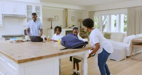 Family Preparing School Bags in Modern Kitchen