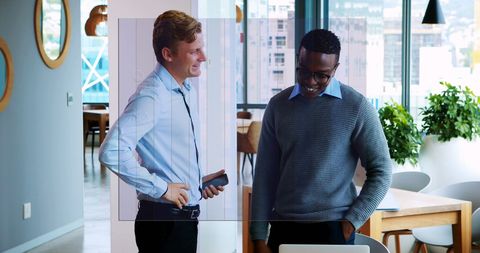 Two businessmen collaborating in modern office space