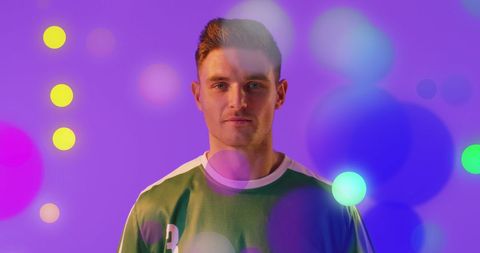 Confident male soccer player with abstract digital effects