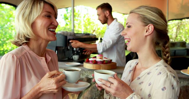 Two Women Enjoying Coffee and Conversation at Outdoor Café - Download Free Stock Images Pikwizard.com