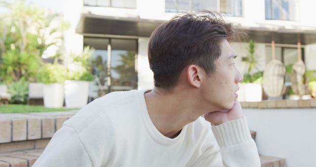 Thoughtful Young Man Relaxing Outdoors in Casual Attire - Download Free Stock Images Pikwizard.com