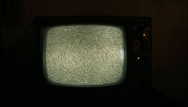 Retro CRT Television with Static in Dimly Lit Room