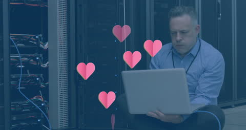 Businessman with Laptop and Hearts Animation in Server Room