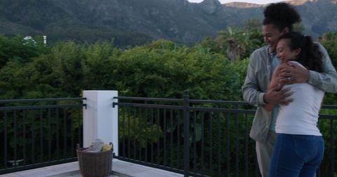 Joyful Couple Embracing on Scenic Balcony with Bananas