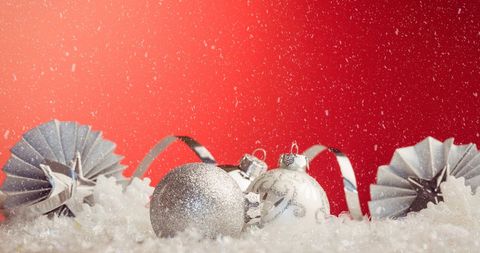 Festive Christmas Baubles on Red Background with Falling Snow - Download Free Stock Images Pikwizard.com