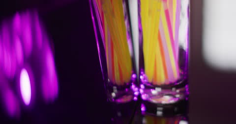 Neon Glow Sticks in Glass Reflecting on Mirror