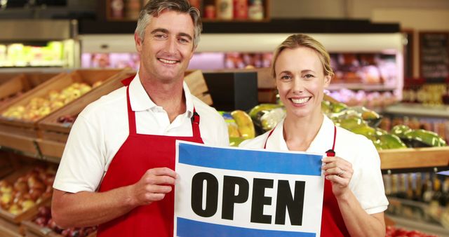 Smiling Grocery Store Owners Holding Open Sign - Download Free Stock Images Pikwizard.com