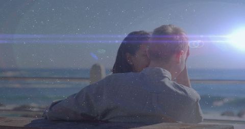 Romantic couple sharing intimate moment by the ocean