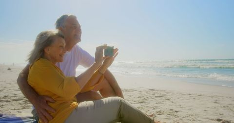 Active senior couple enjoying beach during daytime photography session