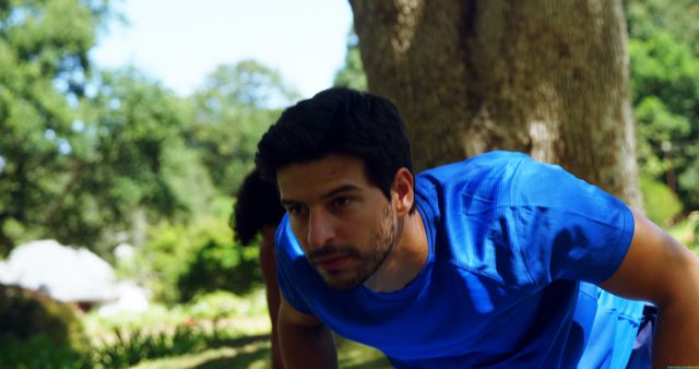 Man in Blue Shirt Exercising in Park - Download Free Stock Images Pikwizard.com