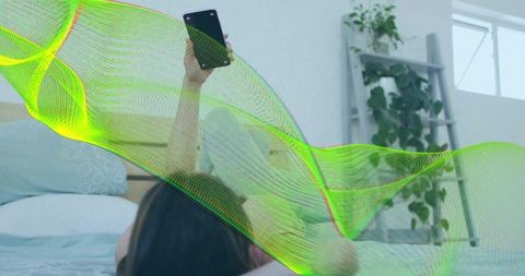 Relaxing in Modern Minimalist Bedroom, Woman Using Smartphone