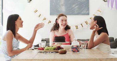 Joyful Birthday Celebration Among Diverse Female Friends at Home