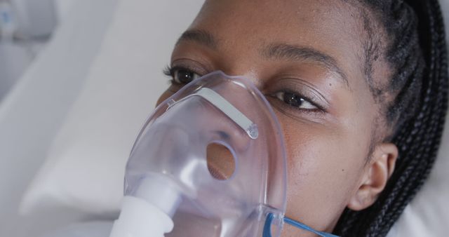 Young woman with oxygen mask lies in hospital bed - Download Free Stock Images Pikwizard.com