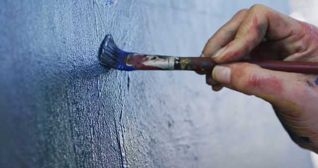 Close Up of Artist's Hand Painting with Brush on Canvas - Download Free Stock Images Pikwizard.com