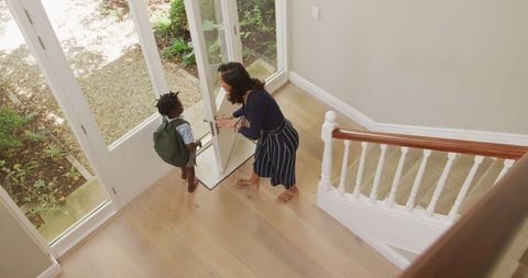 Mother Bidding Farewell to Son at Doorway for School - Download Free Stock Images Pikwizard.com
