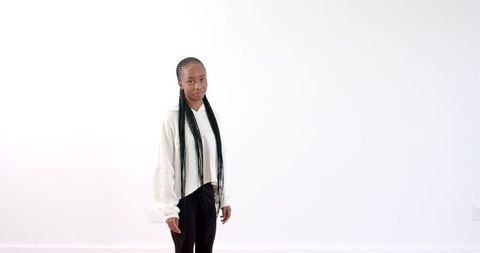 Young Woman Standing in Minimalist Room With Confidence - Download Free Stock Images Pikwizard.com