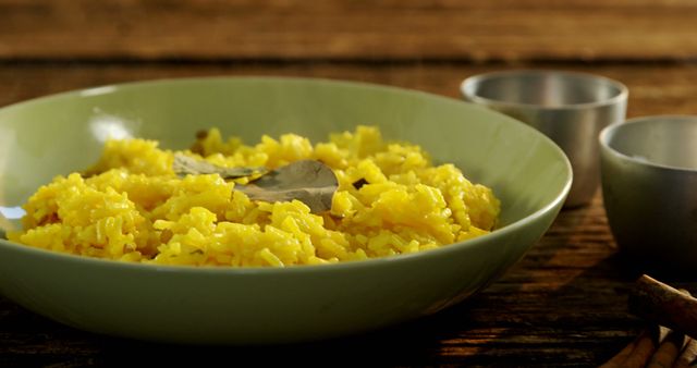 Delicious Yellow Rice in Green Bowl on Rustic Wooden Table - Download Free Stock Images Pikwizard.com