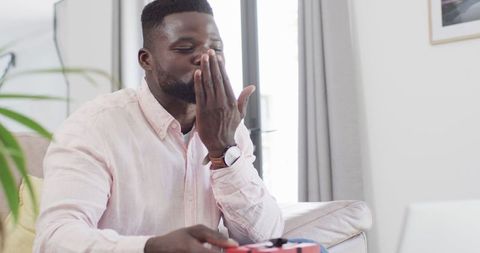 Professional working from home on video call, creating cozy office environment