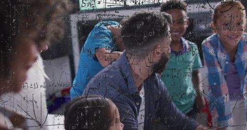 Bearded teacher guiding elementary students in hands-on math lesson with equations overlay