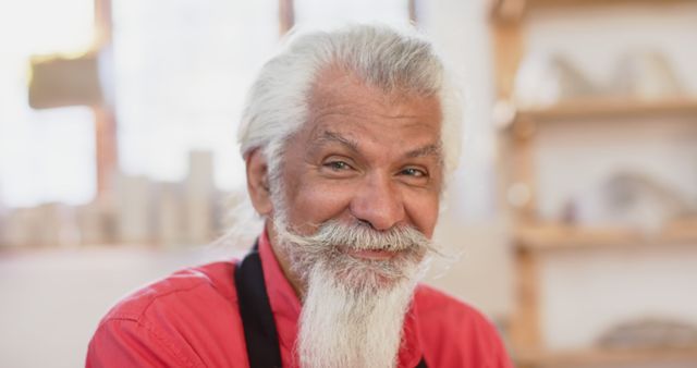 Friendly Senior Man with Long Beard Smiling in Workshop - Download Free Stock Images Pikwizard.com