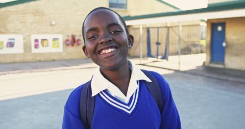 Smiling African Schoolboy in Uniform Backpack Outdoors