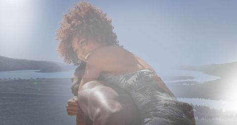 Joyful African American Woman Embracing Relaxation by Tranquil Water